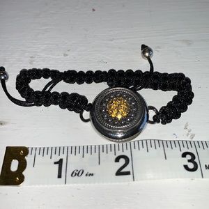 Adjustable braided black cord bracelet with one interchangeable snaps.NWOT
